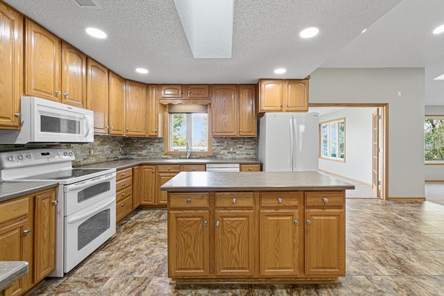 kitchen with recessed lighting, white appliances, a textured ceiling, and decorative backsplash