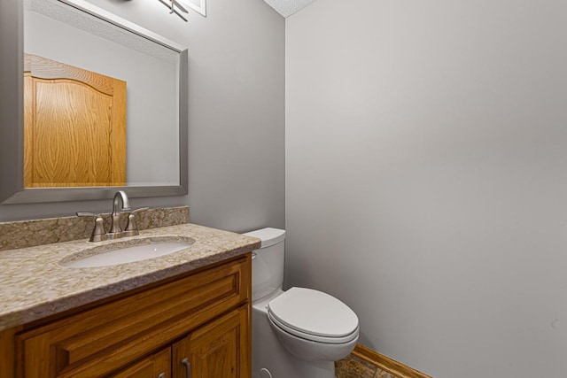 bathroom featuring toilet and vanity
