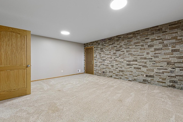 spare room featuring baseboards and carpet