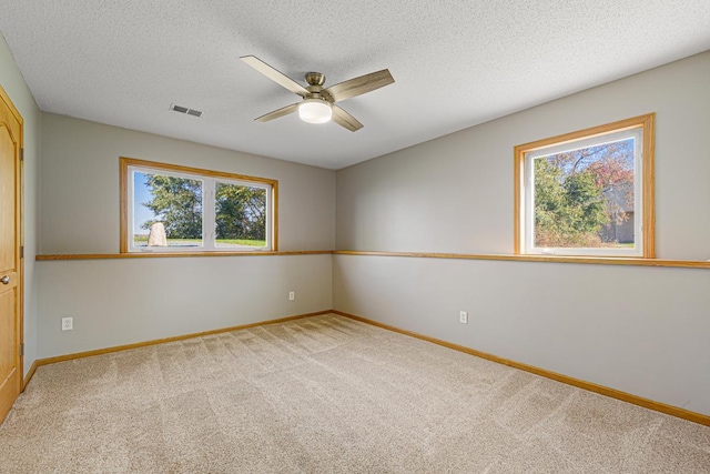empty room with baseboards, a ceiling fan, and carpet