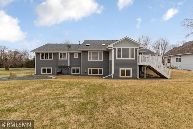 rear view of property with a deck, stairway, a yard, and central air condition unit