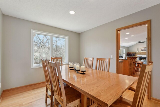 dining area with recessed lighting, a ceiling fan, light wood-style flooring, and baseboards