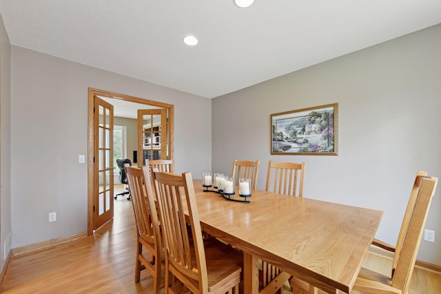 dining area featuring baseboards, recessed lighting, light wood-style floors, and french doors