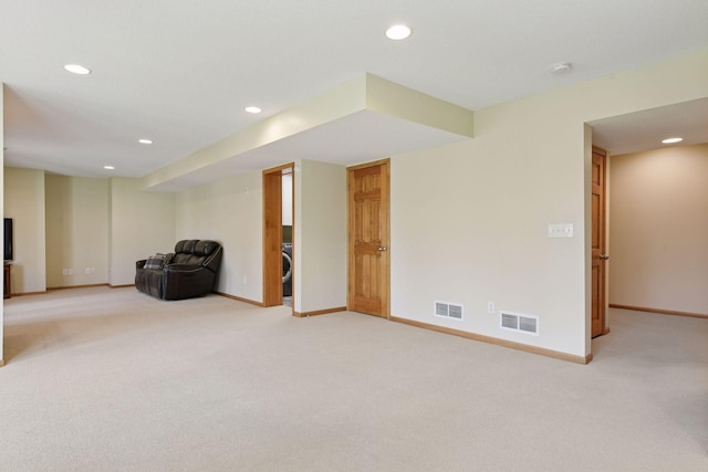 finished basement with baseboards, recessed lighting, visible vents, and light colored carpet
