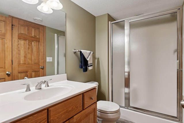 full bath with a stall shower, a textured ceiling, and toilet