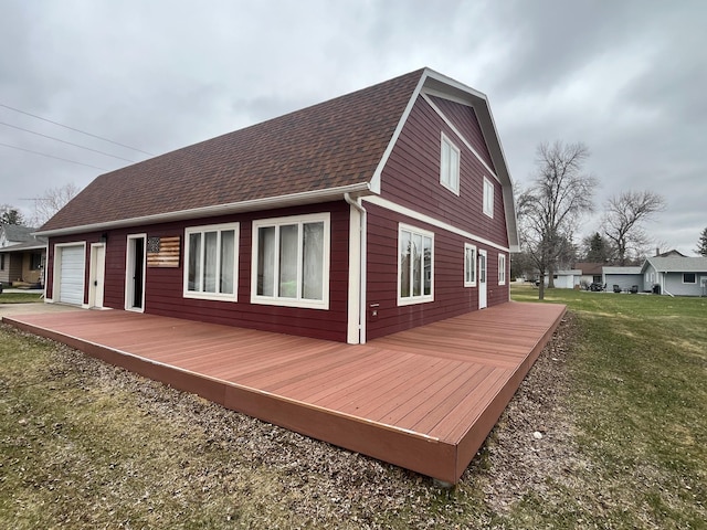 130 2nd St NE, Mcintosh, MN 56556 - rear view of house with roof with shingles, a lawn, a deck, and a gambrel roof