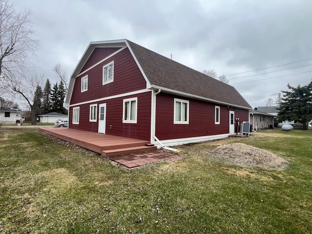 130 2nd St NE, Mcintosh, MN 56556 - rear view of property with a lawn, a gambrel roof, roof with shingles, and a wooden deck