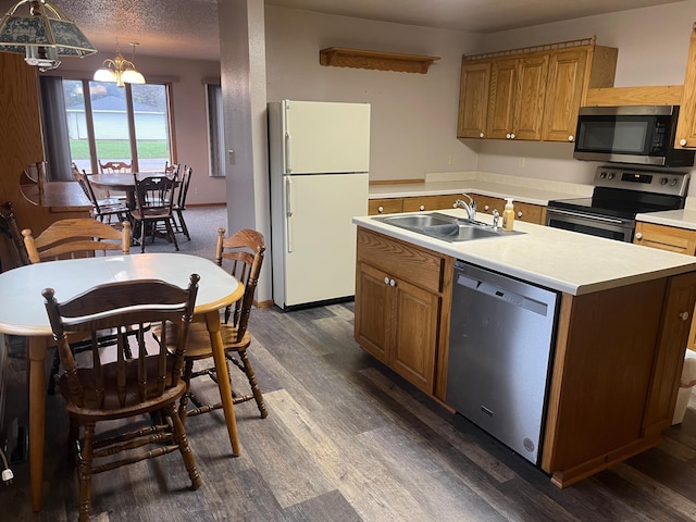 130 2nd St NE, Mcintosh, MN 56556 - kitchen featuring light countertops, appliances with stainless steel finishes, a sink, and dark wood-type flooring