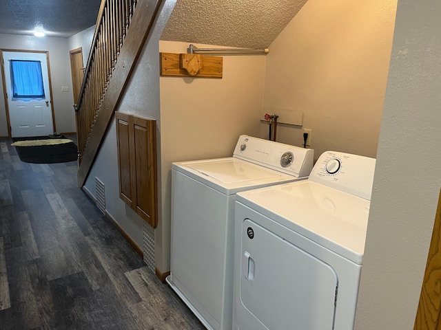 130 2nd St NE, Mcintosh, MN 56556 - clothes washing area featuring dark wood-style flooring, separate washer and dryer, a textured ceiling, and laundry area