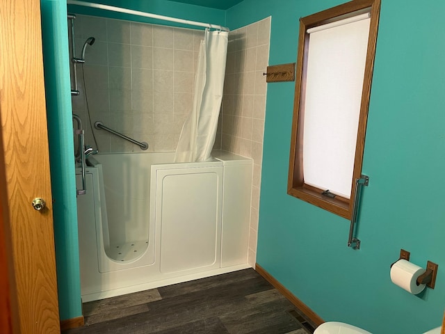 130 2nd St NE, Mcintosh, MN 56556 - bathroom featuring wood finished floors and a shower with curtain