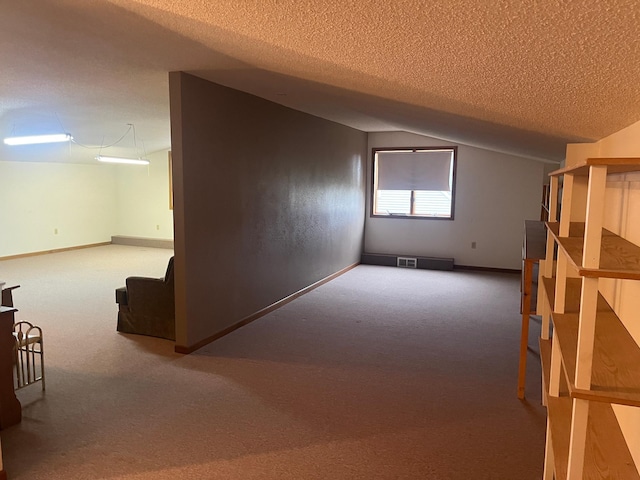 130 2nd St NE, Mcintosh, MN 56556 - bonus room featuring visible vents, a textured ceiling, carpet, and lofted ceiling
