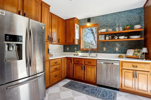 kitchen with open shelves, a sink, light countertops, stainless steel appliances, and backsplash