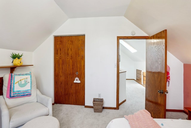 bedroom featuring carpet floors, baseboards, and vaulted ceiling