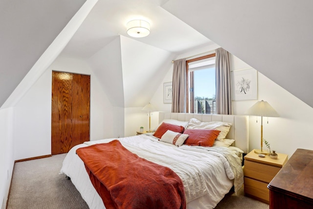carpeted bedroom featuring lofted ceiling