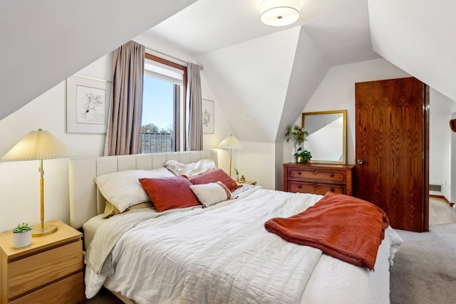carpeted bedroom with visible vents and lofted ceiling
