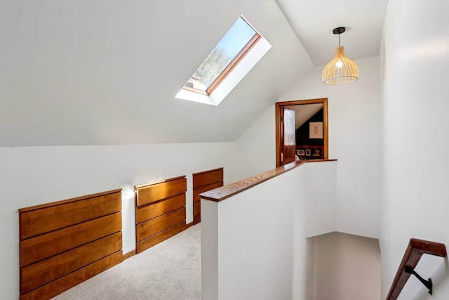 interior space with carpet flooring and lofted ceiling with skylight