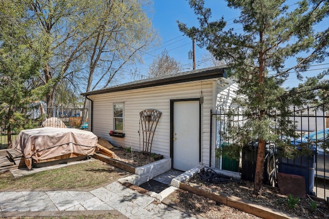 view of outbuilding featuring fence