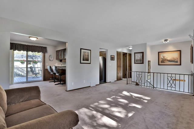living area with carpet flooring and baseboards