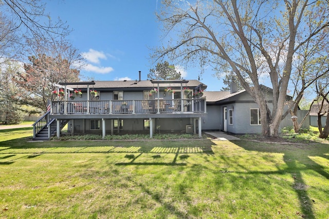 rear view of property featuring a deck, stairs, and stucco siding