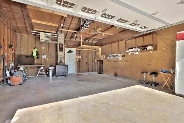 garage featuring freestanding refrigerator and a garage door opener