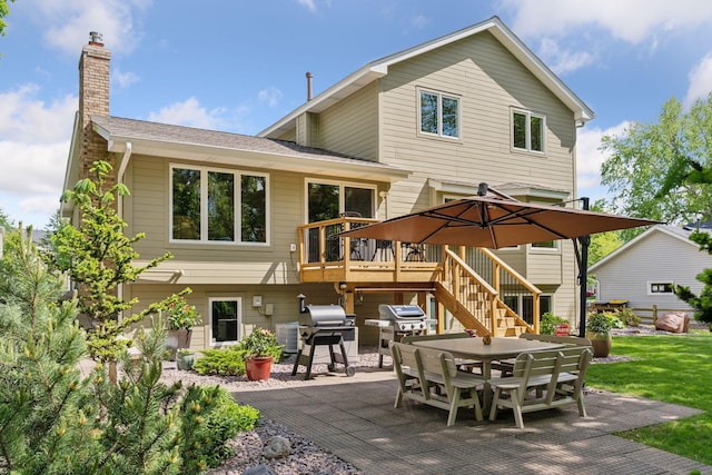 3861 Westbury Dr, Eagan, MN 55123 - rear view of property featuring a patio, outdoor dining space, a deck, a chimney, and stairway