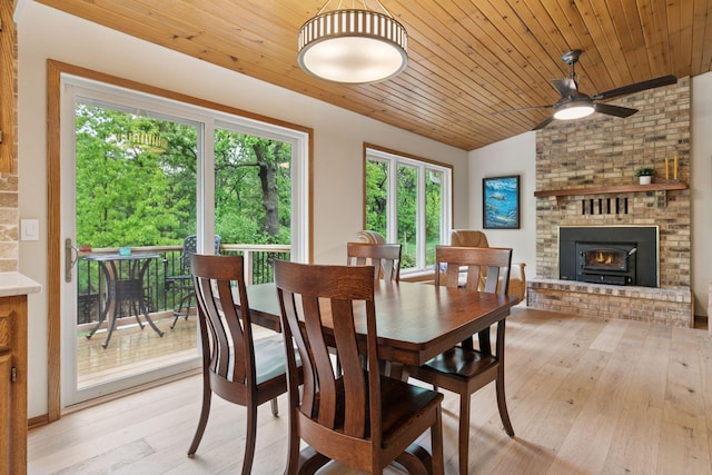 3861 Westbury Dr, Eagan, MN 55123 - dining space with ceiling fan, vaulted ceiling, light wood-type flooring, a brick fireplace, and wooden ceiling