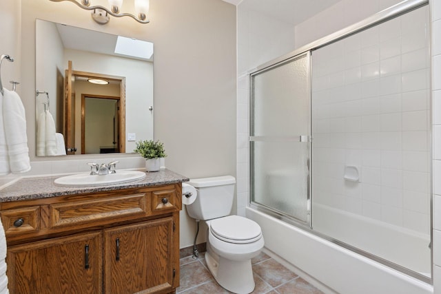 3861 Westbury Dr, Eagan, MN 55123 - bathroom featuring toilet, vanity, combined bath / shower with glass door, and tile patterned flooring