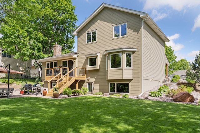 3861 Westbury Dr, Eagan, MN 55123 - back of property with stairway, a patio, a wooden deck, a yard, and a chimney