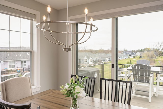 dining area featuring a residential view and a notable chandelier