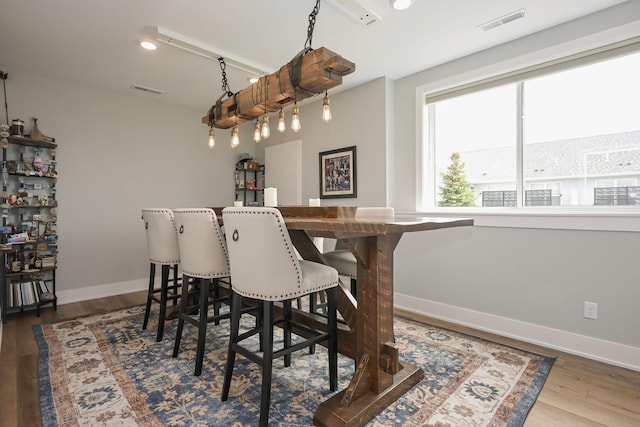 dining room featuring visible vents, recessed lighting, baseboards, and wood finished floors