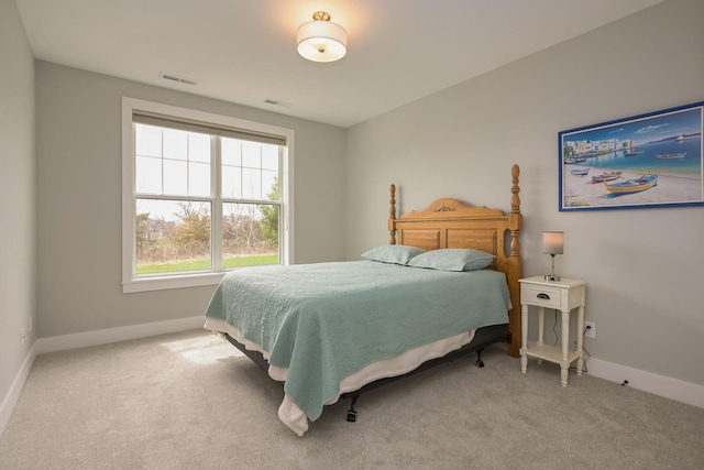 carpeted bedroom featuring visible vents and baseboards
