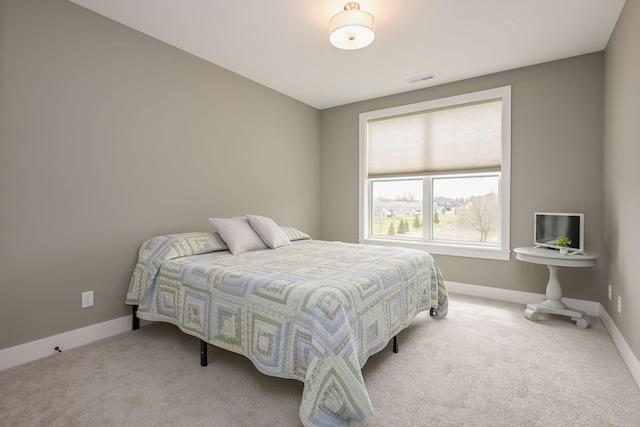 carpeted bedroom featuring baseboards