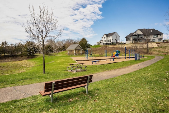 view of home's community with a lawn and playground community