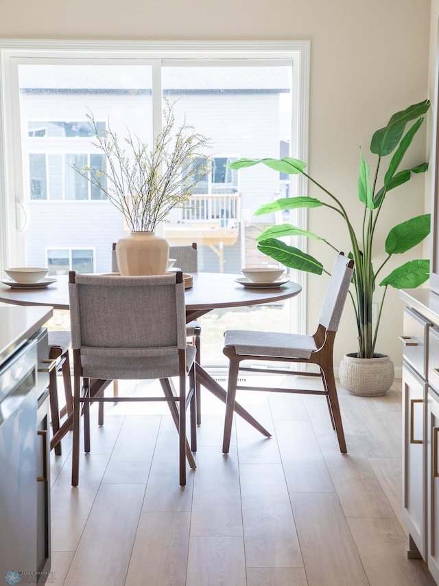dining space featuring light wood finished floors