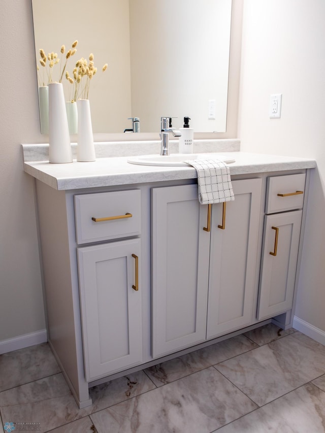 bathroom with vanity and baseboards