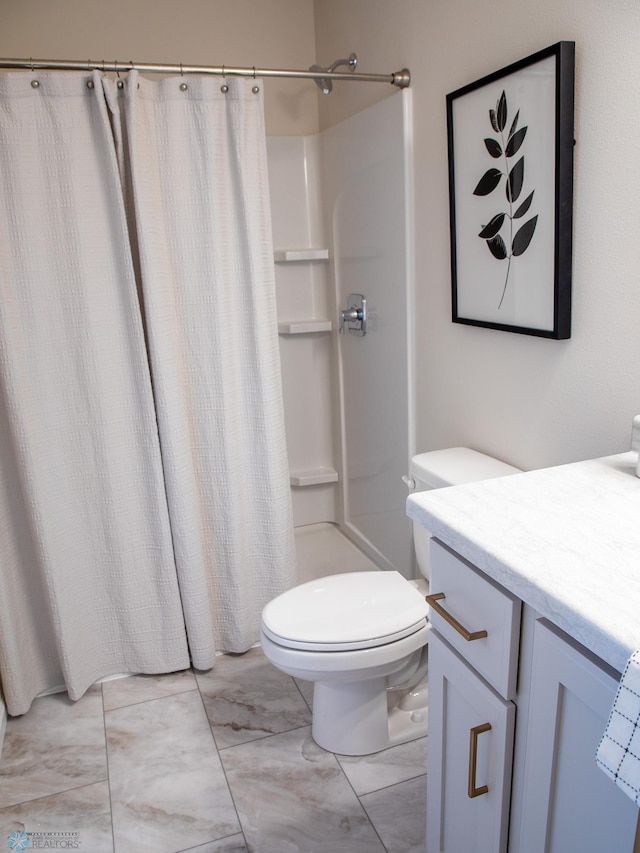 full bath with a shower with curtain, vanity, toilet, and marble finish floor