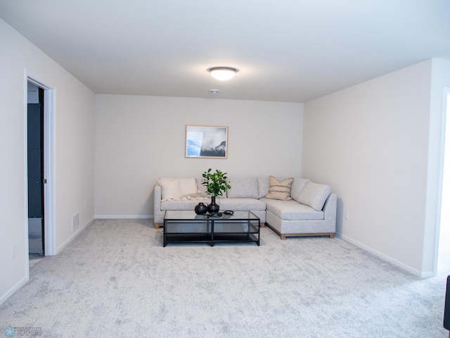 carpeted living room featuring visible vents and baseboards