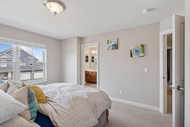 231 Prairie Way N, Bayport, MN 55003 - bedroom with light colored carpet, baseboards, ensuite bath, and a textured ceiling