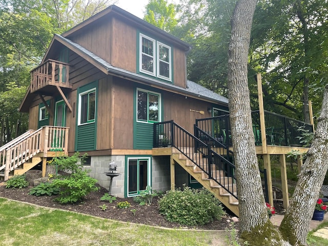 39315 Little Mo Rd, Clitherall Twp, MN 56524 - back of property featuring stairs, a deck, and a balcony