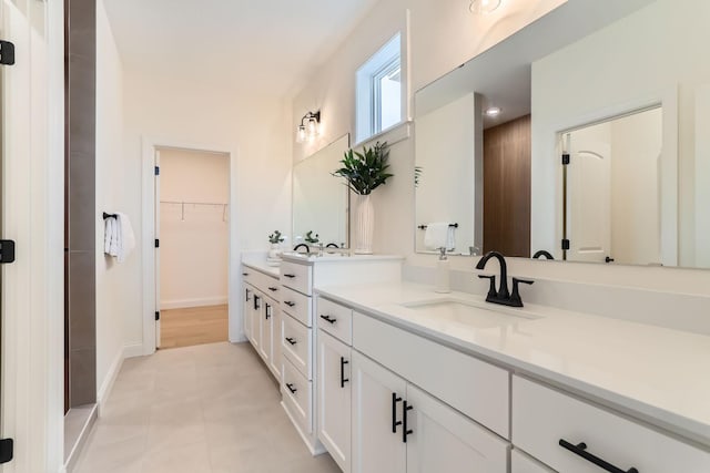 4501 Overlook Dr, Bloomington, MN 55437 - full bathroom with vanity, baseboards, tile patterned floors, and a walk in closet