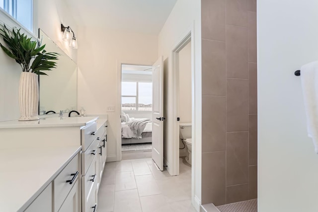 4501 Overlook Dr, Bloomington, MN 55437 - ensuite bathroom featuring a tile shower, tile patterned floors, vanity, toilet, and ensuite bath