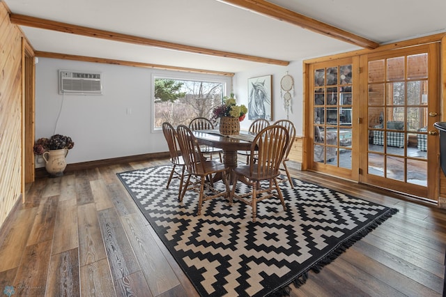 dining area featuring hardwood / wood-style flooring, baseboards, beam ceiling, and a wall mounted AC