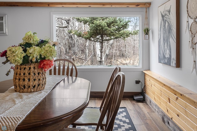 interior space featuring baseboards, wood finished floors, and plenty of natural light