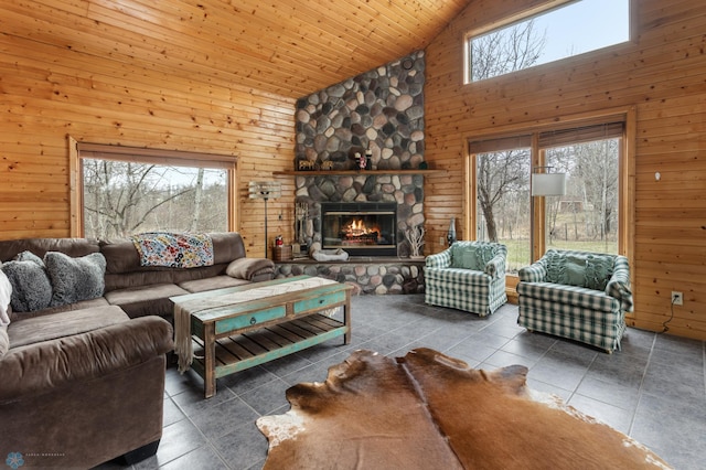 tiled living area featuring high vaulted ceiling, wood walls, and a fireplace