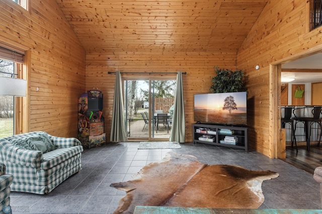 living room featuring high vaulted ceiling, tile patterned flooring, and wooden walls