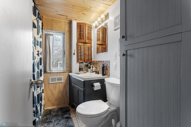 bathroom featuring toilet, visible vents, tile patterned flooring, wood ceiling, and vanity
