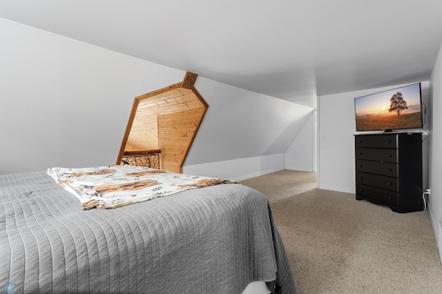 bedroom featuring lofted ceiling and baseboards