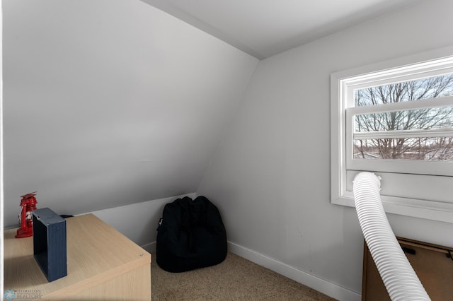 office area featuring vaulted ceiling, carpet flooring, and baseboards