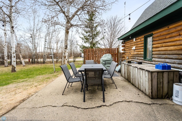 view of patio with outdoor dining area and fence