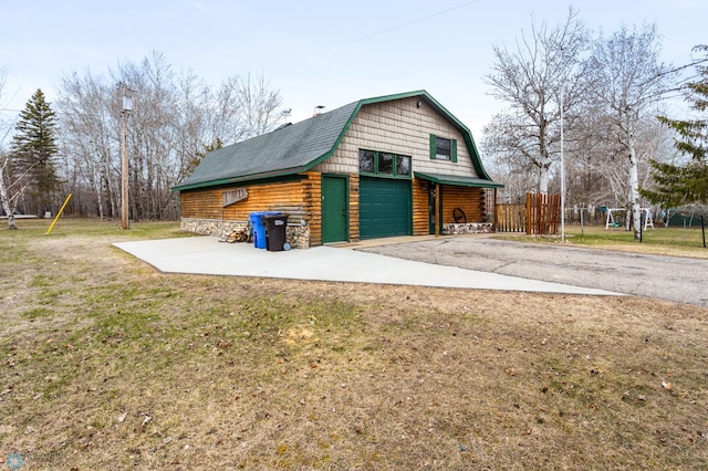 garage featuring aphalt driveway and a garage